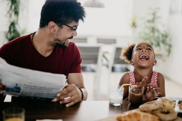 Happy dad and daughter laughing at kitchen counter | The Grove Frisco,  a new home community in Frisco, TX