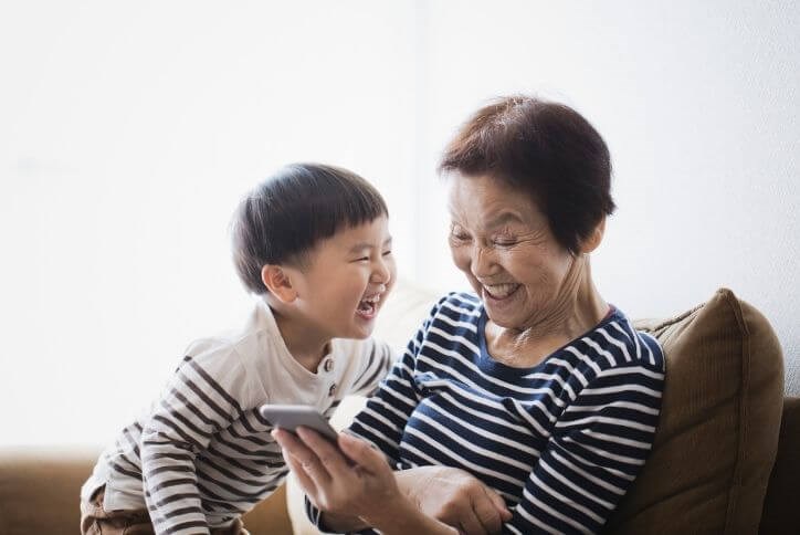 Happy grandmother and grandchild laughing | The Grove Frisco in TX